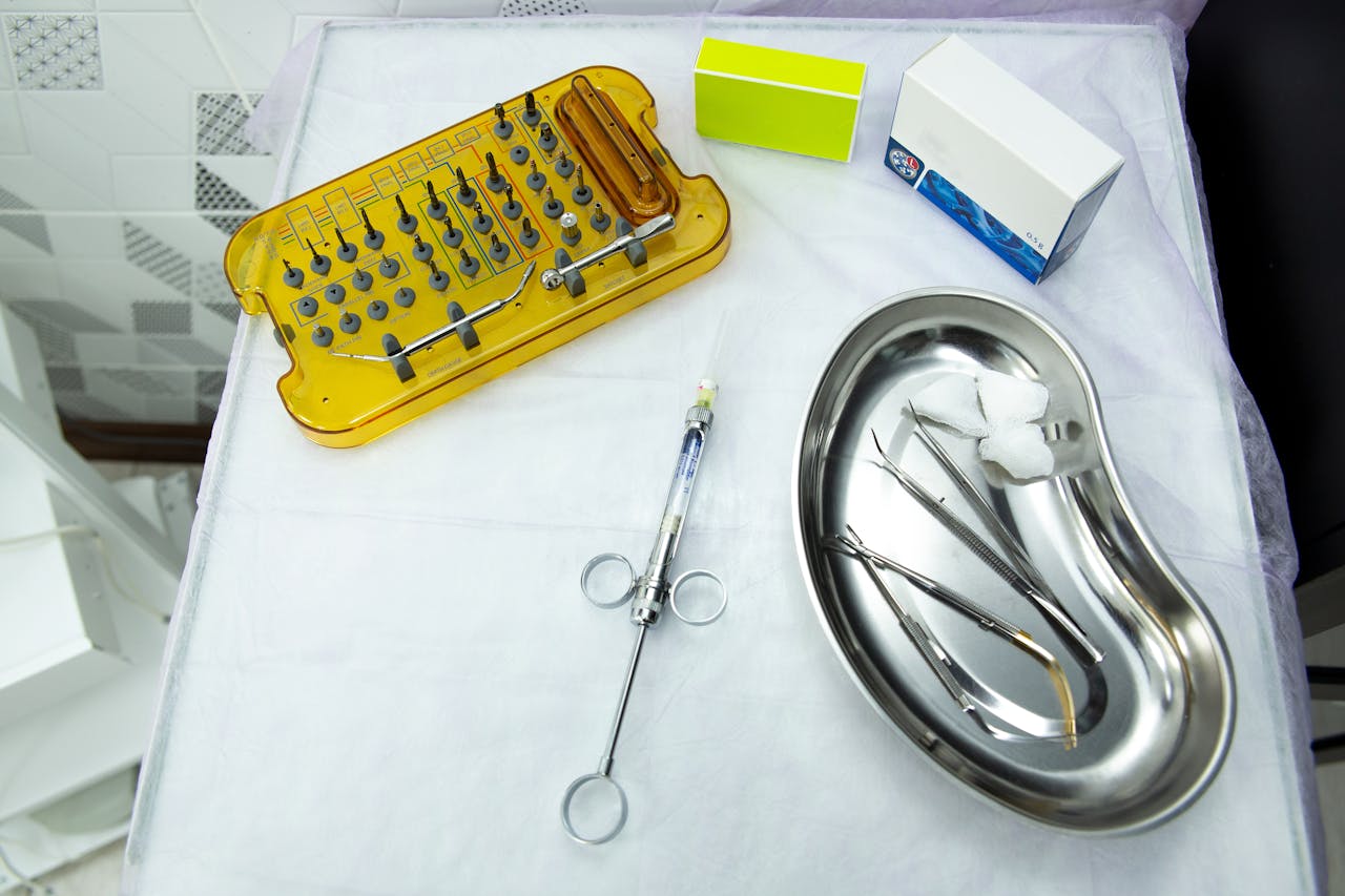 A set of dental and medical tools on a sterile tray, ideal for clinical and healthcare settings.